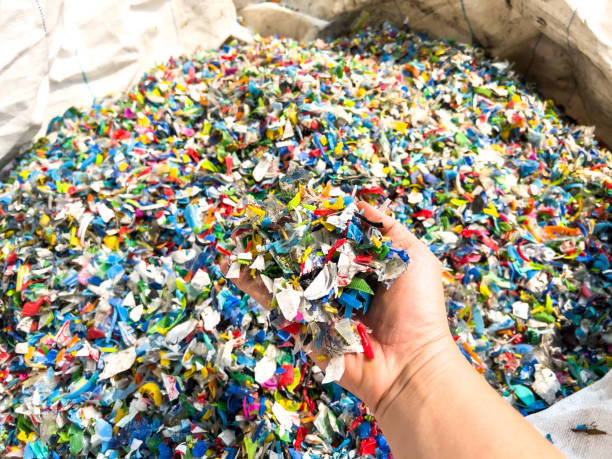 Hand holding Bottle flake,PET bottle flake,Plastic bottle crushed,Small pieces of cut colorful plastic bottles